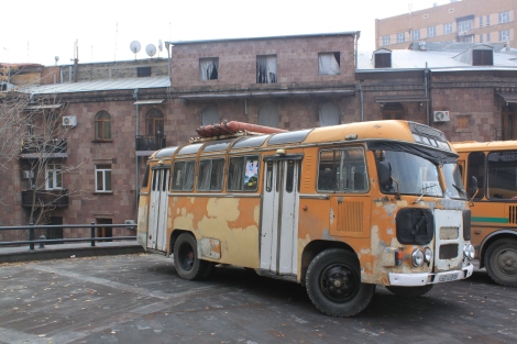 An old bus fueled by propane tanks strapped to the roof